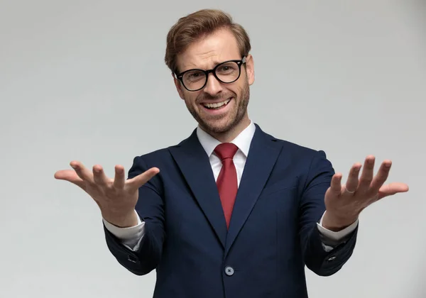 Businessman standing and looking at camera happily surprised — Stock fotografie