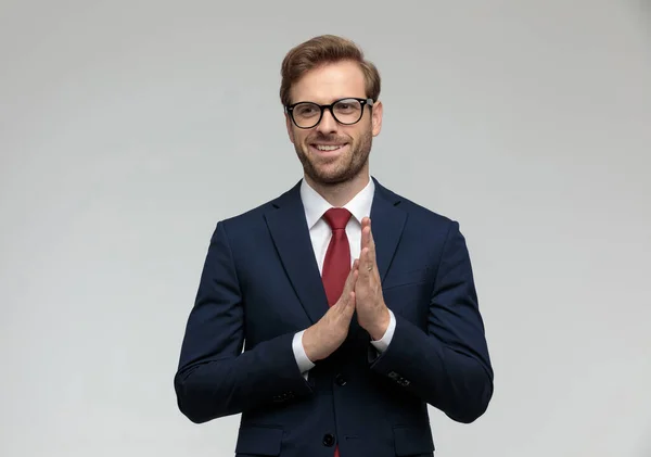Businessman standing and rubbing hands happy — Stockfoto