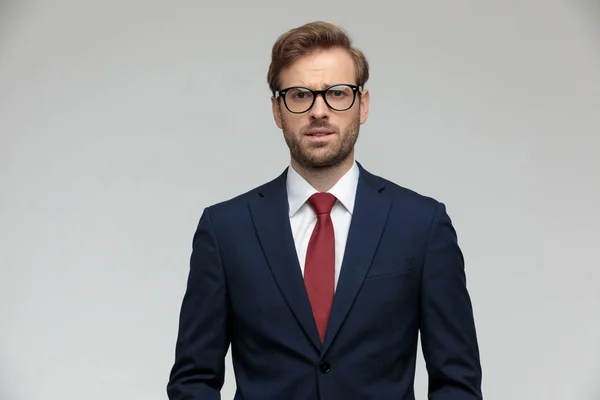 Businessman standing and looking at camera fearful — Stockfoto