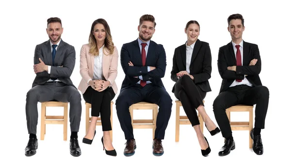 Team of 5 positive businessmen smiling while sitting — Stok fotoğraf