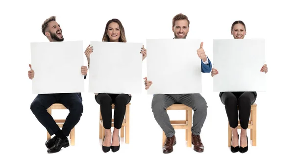 4 businessmen holding empty billboards while giving thumbs up — ストック写真