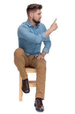 young casual man in denim shirt showing finger and warning