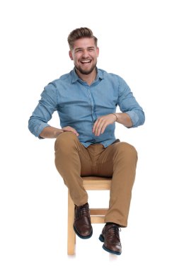 happy casual man wearing denim shirt and laughing