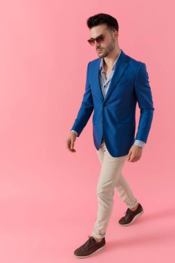 sexy young smart casual guy walking in a fashion pose