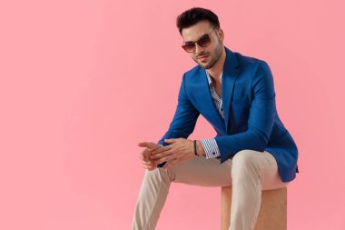 happy young smart casual model touching palms