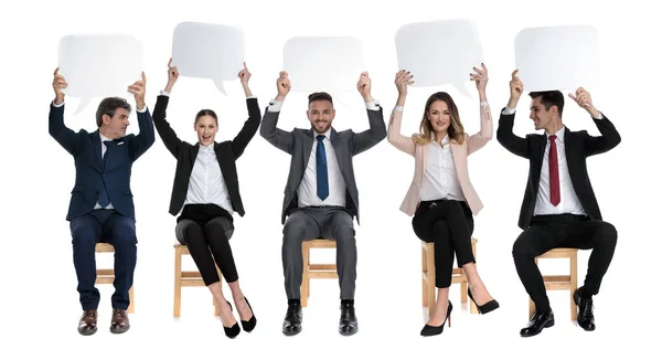 Team Happy Businessmen Holding Empty Speech Bubble Heads While Sitting — Stock Photo, Image