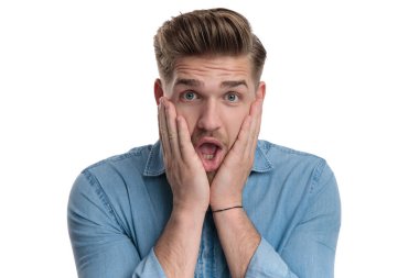 Gömlek giyerken elini yüzüne koyan, beyaz stüdyo arka planında duran...