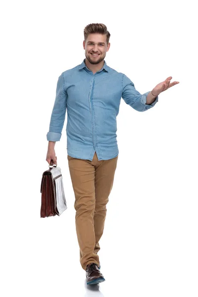 Smiling Casual Man Presenting While Holding Briefcase Stepping White Studio — Stock Photo, Image