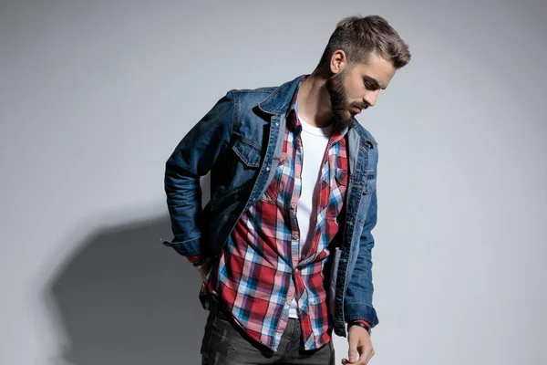 Thoughtful Fashion Model Fixing His Jacket Looking While Standing Gray — Stock Photo, Image