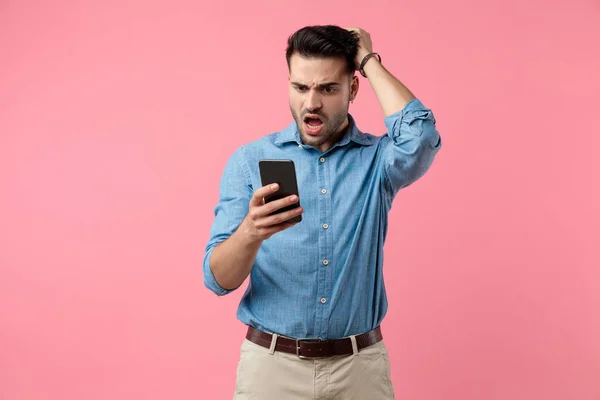 Upset Young Casual Guy Holding Phone Reading Bad News Holding — Stock Photo, Image
