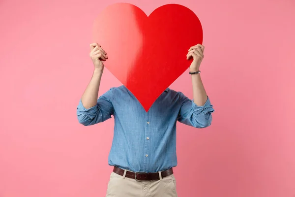 Casual Guy Hiding Big Red Heart Standing Pink Background — Stock Photo, Image