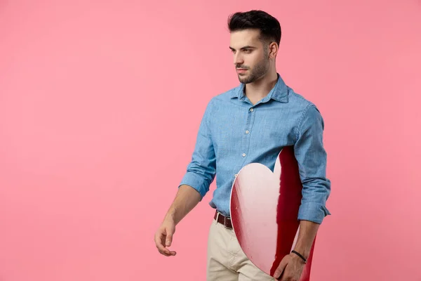 Sexy Young Casual Guy Looking Side Holding Big Red Heart — Stock Photo, Image