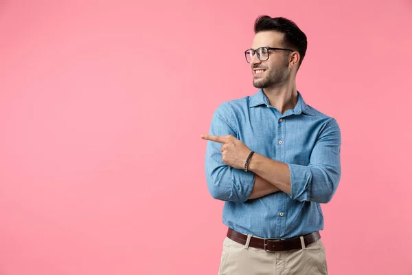 Happy Young Guy Looking Side Pointing Finger Smiling Pink Background — Stock Photo, Image