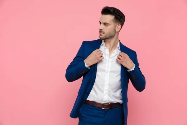 Confident Businessman Adjusting His Jacket Looking Away While Wearing Blue — Stock Photo, Image