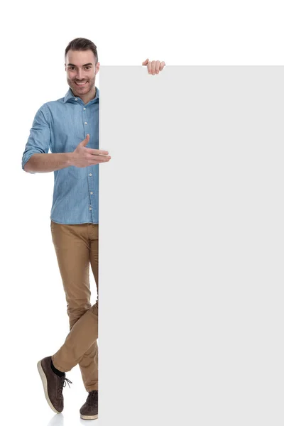 Happy Casual Man Smiling Presenting Blank Billboard While Wearing Blue — Stock Photo, Image