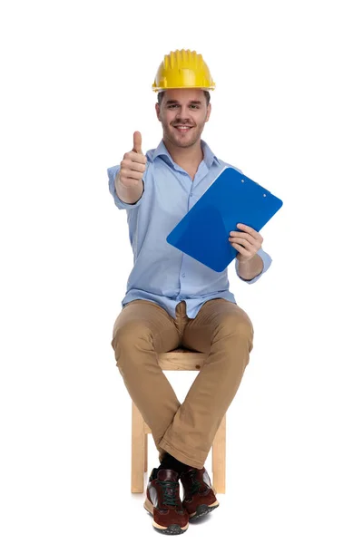 Casual Man Wearing Hard Hat Gesturing Clipboard Hand While Sitting — Stock Photo, Image