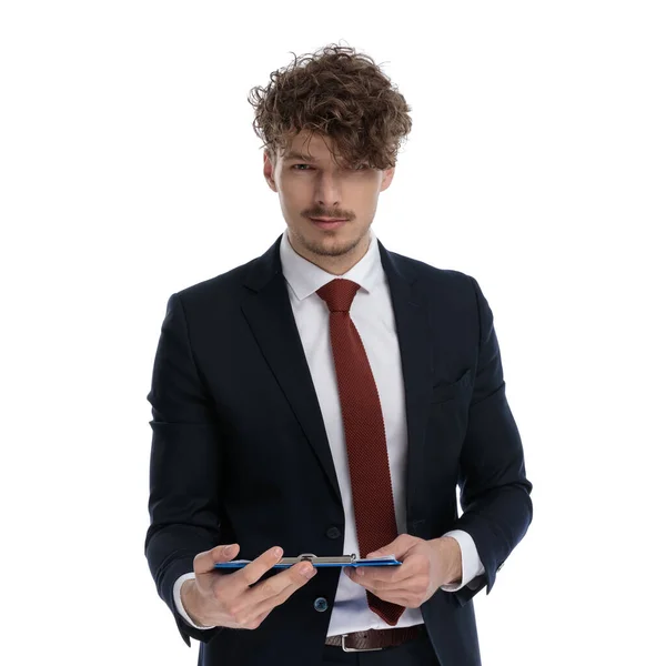 Serious Businessman Holding Clipboard Looking Forward While Wearing Suit Standing — Stock Photo, Image