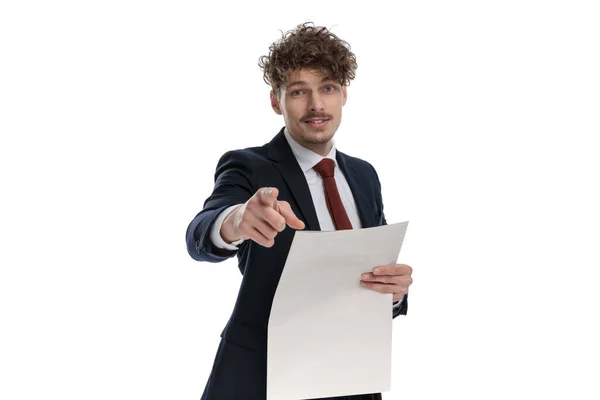 Happy Businessman Holding Newspaper Pointing Forward While Wearing Suit Standing — Stock Photo, Image