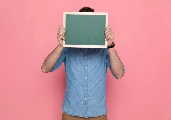 Casual Man Hiding His Face Behing Board Wearing Blue Shirt — Stock Photo, Image