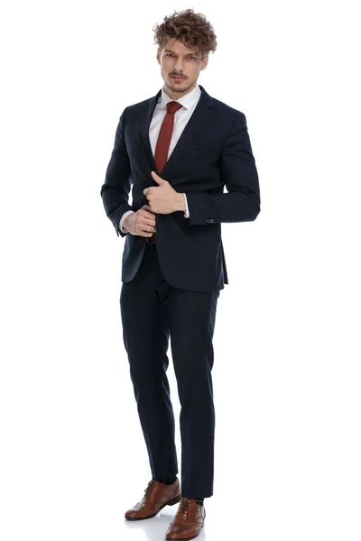 Serious Businessman Fixing Jacket Frowning While Wearing Suit Standing White — Stock Photo, Image