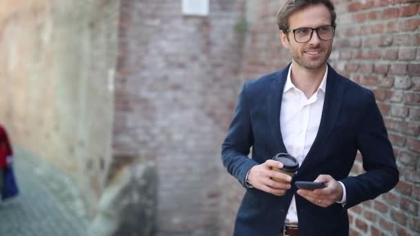 Sexy Young Businessman Walking Next Brick Wall Wearing Eyeglasses Holding — Stock Video