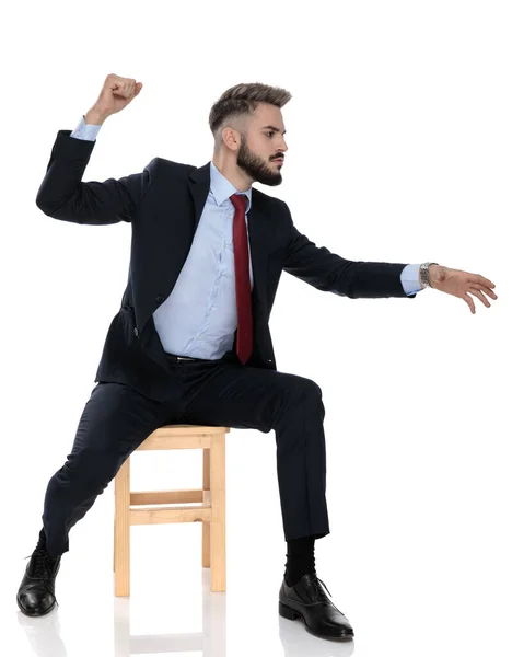 Angry Young Businessman Punching Chasing Sitting Isolated White Background — Stock Photo, Image