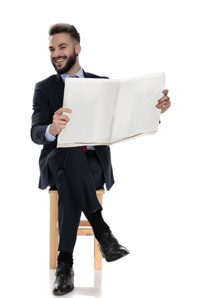 Feliz Joven Empresario Leyendo Periódico Riendo Sentado Aislado Sobre Fondo —  Fotos de Stock