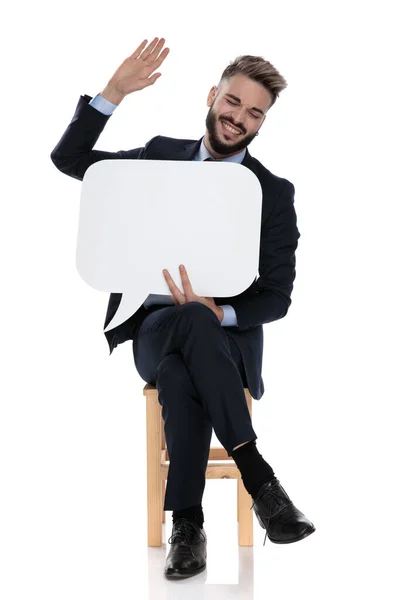 Jovem Empresário Feliz Segurando Bolha Discurso Rindo Sentado Isolado Fundo — Fotografia de Stock