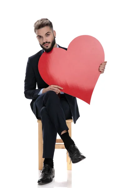 Sexy Young Businessman Holding Big Red Heart Sitting Isolated White — Stock Photo, Image