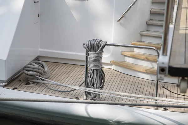 Ropes on board a ship neatly knotted around a rail