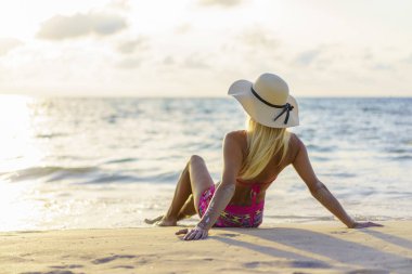 Gün batımında sahilde bir kadın