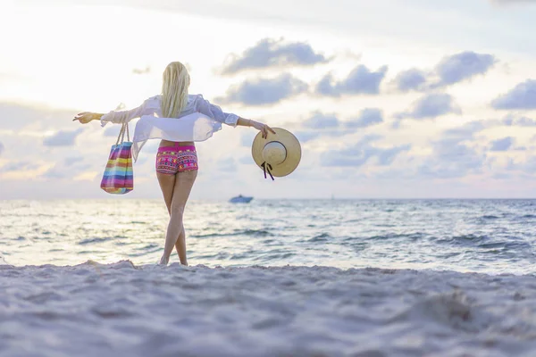 Kobieta na plaży o zachodzie słońca — Zdjęcie stockowe