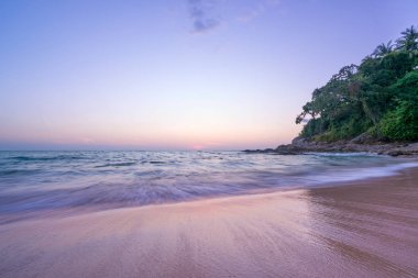 Surin beach at sunset in Phuket island  clipart