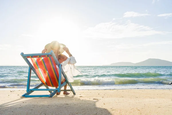 Mujer relajante en el sofá cama de sol silla de estar en vacaciones —  Fotos de Stock