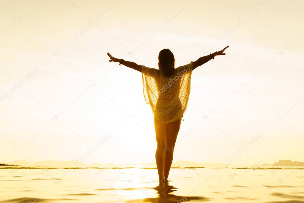 Silhouette of a Beautiful Woman at the beach in Thailand at suns