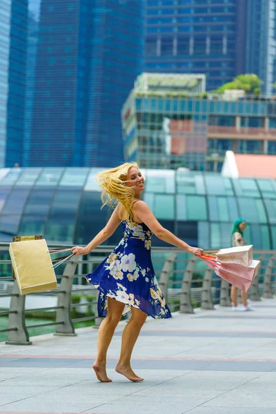 Happy shopper with shopping bags at Marina bay in SIngapore