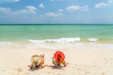 Two beautiful women enjoying the tropical beach in Thailand clipart