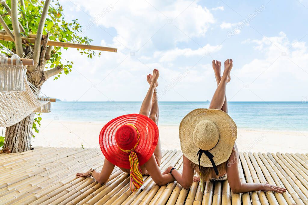 Two beautiful women enjoying the tropical beach in Thailand