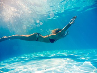 Kadın yüzme havuzunda suyun altında.