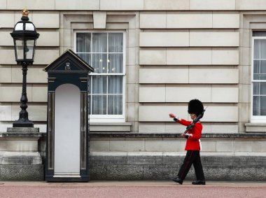The Queen's Guard on duty at Buckingham Palace, the official residence of the Queen of England clipart