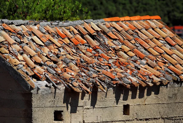 Damaged roof tile on house