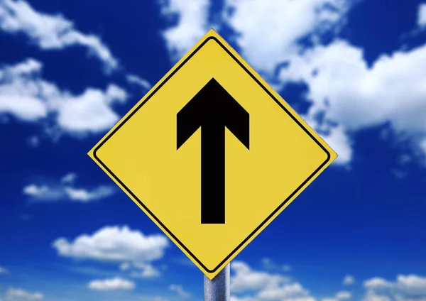 Yellow road sign with cloudscape with arrow symbol — Stock Photo, Image