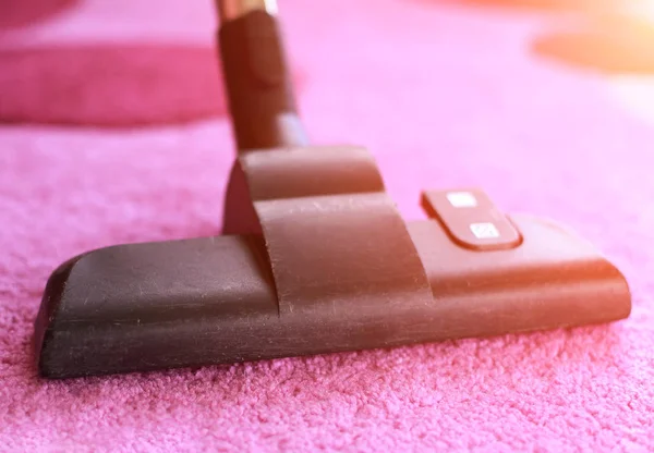 Vacuum cleaning with hoover on rug — Stock Photo, Image