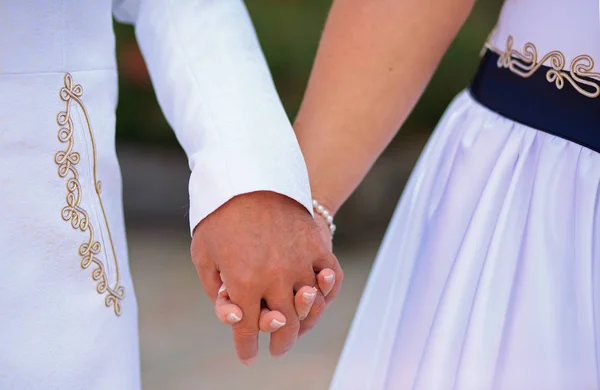 Wedding couple walking together hand in hand — Stock Photo, Image
