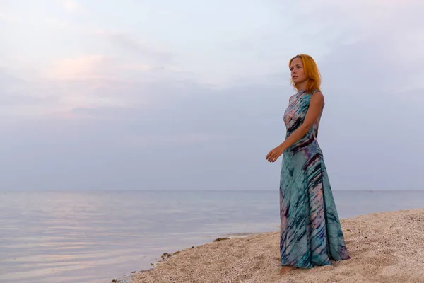 Young red woman on a beach — Stock Photo, Image