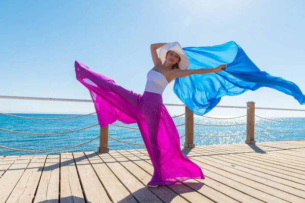 Beautiful woman wearing hat and pink skirt — Stock Photo, Image