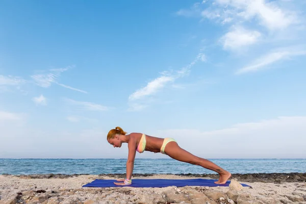 Slim woman practicing plank pose — Stock Photo, Image