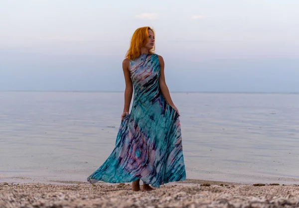 Young red woman on a beach — Stock Photo, Image