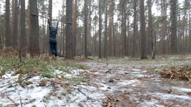 Young Athletic Man Performs Pullups in forest — Stock Video