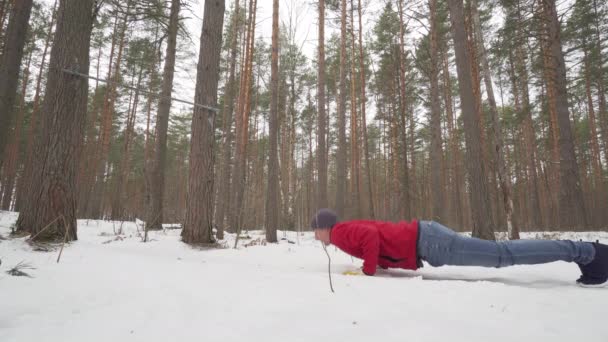 Joven atlético haciendo ejercicio en el bosque — Vídeos de Stock